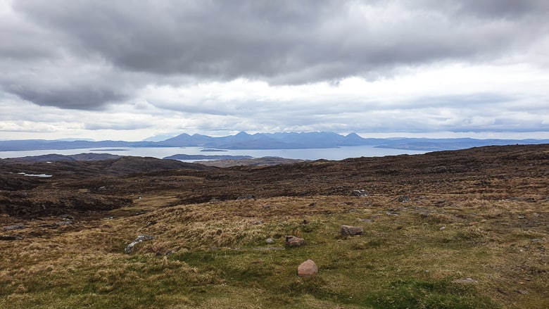 A panoramic view of islands and dark clouds at Bealach Na Ba