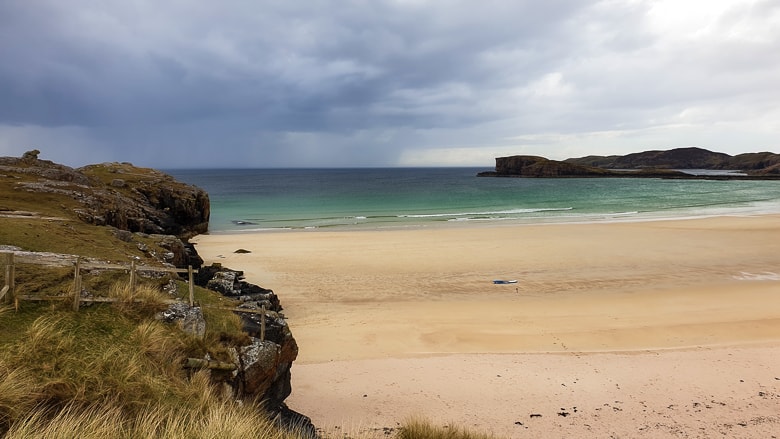 A surfboard lying on the sand at Oldshoremore Beach